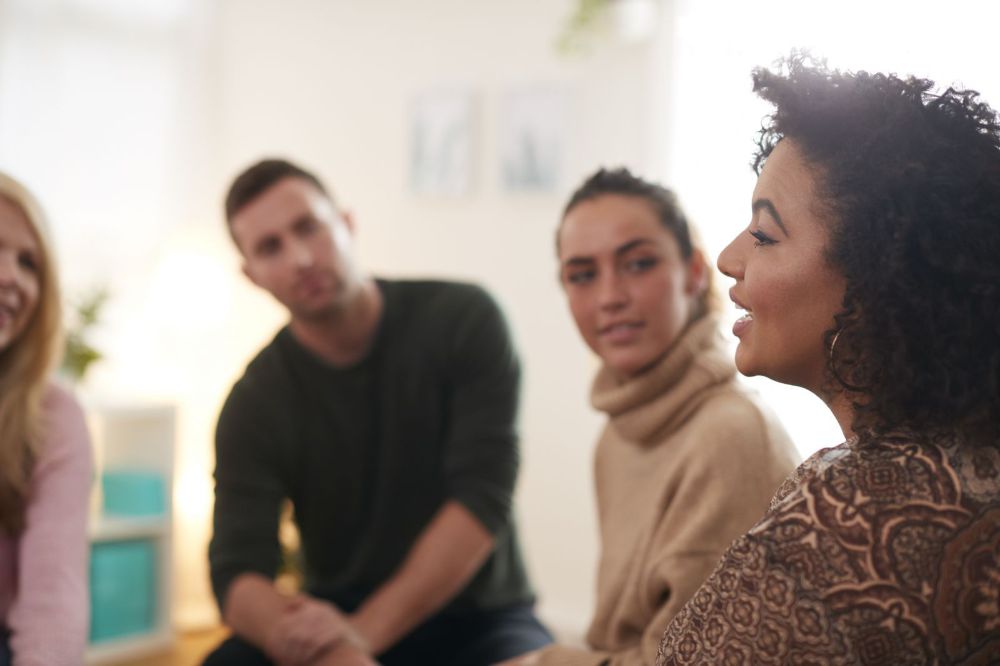 Woman Speaking At Support Group Meeting