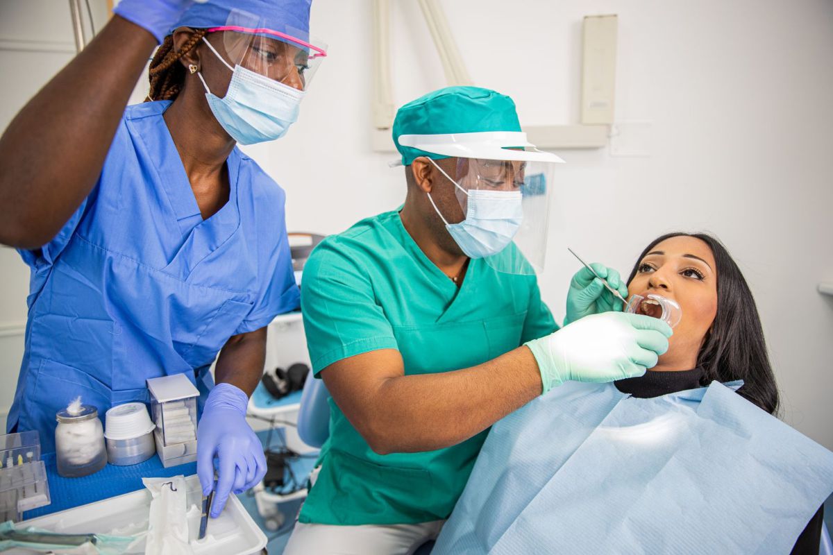 Two detal technicians working with a patient