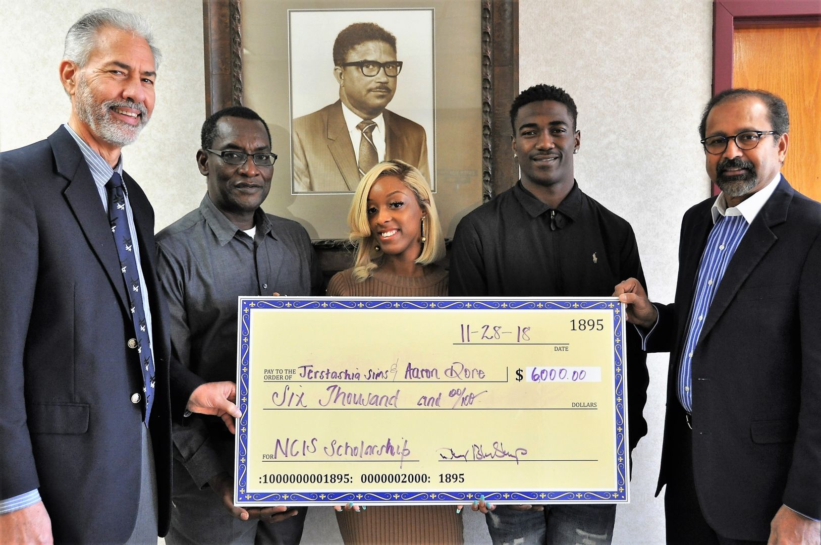Fort Valley State University seniors Jerstashia Sims and Aaron Dore (center) accept $3,000 each from the National Crop Insurance Services (NCIS). They are pictured with (from left to right) Dr. Daniel Blankenship, interim dean for the College of Agriculture, Family Sciences and Technology; Dr. Mohammed Ibrahim, coordinator and professor of the agricultural economics program; and Dr. Govind Kannan, associate dean for research.