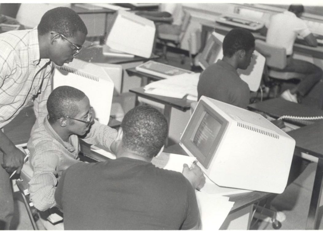 Students at early word processor in historic photo