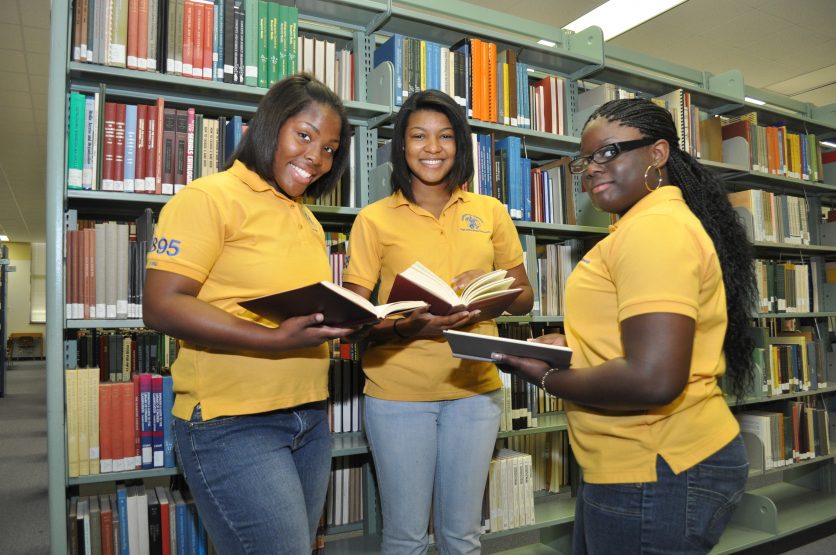 Two students talking seriously in a library