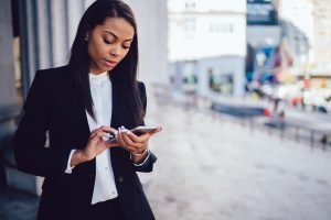 Professoinally dressed student holding cell phone