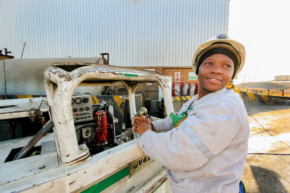 Female Miner operating vehicle machinery used to move ore rocks 