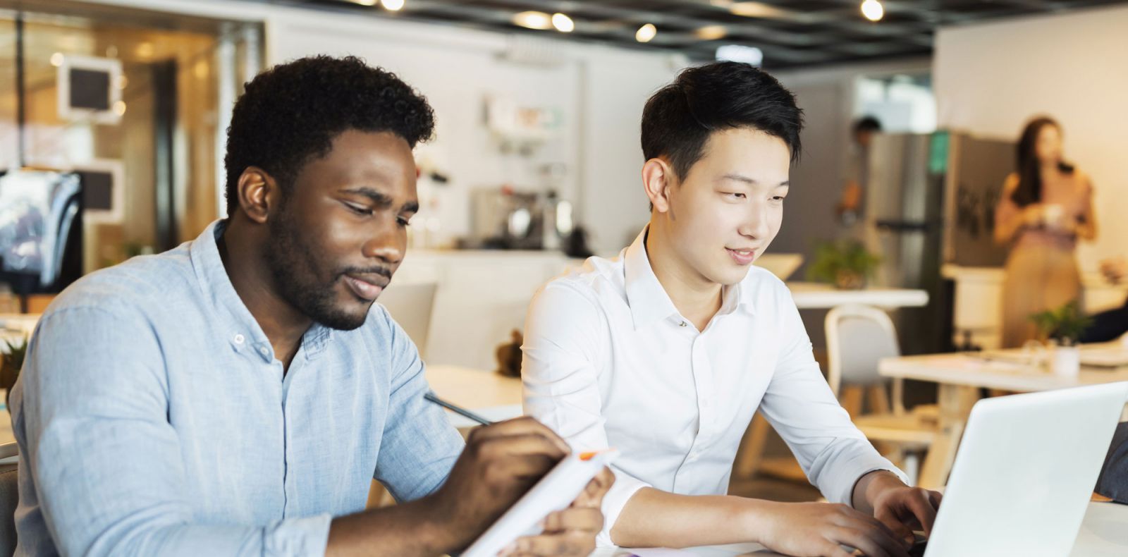 Two young man seated at table in classroom