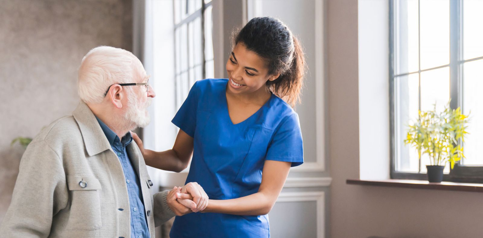 Nurse assisting a geriatric patient