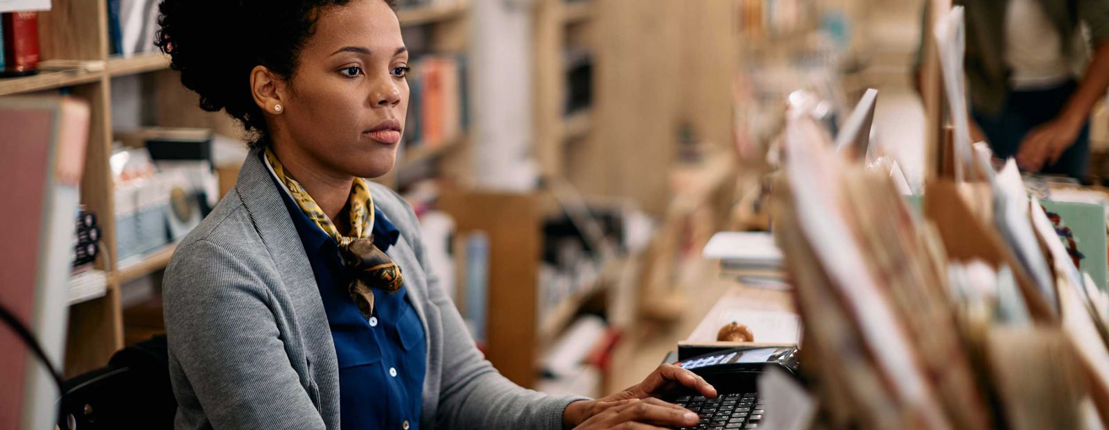 Student working in library environment