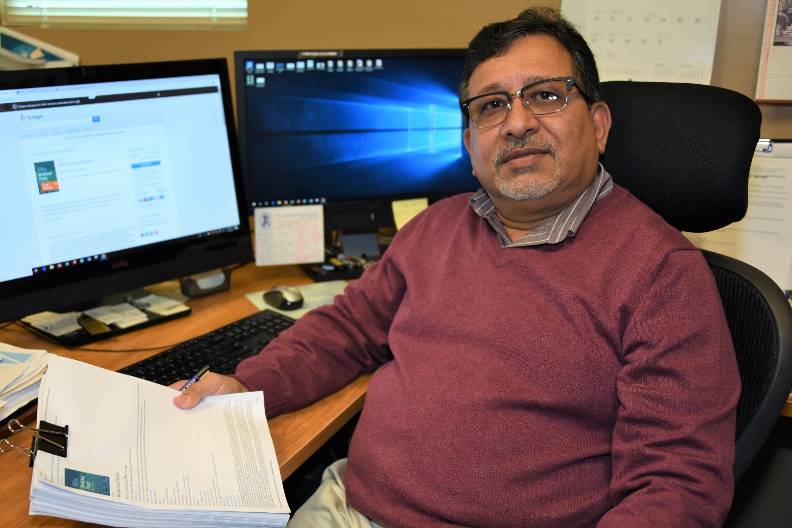 Dr. Nirmal Joshee, a Fort Valley State University professor of plant science, holds a draft copy of the newly released book “Medicinal Plants: From Farm to Pharmacy.”