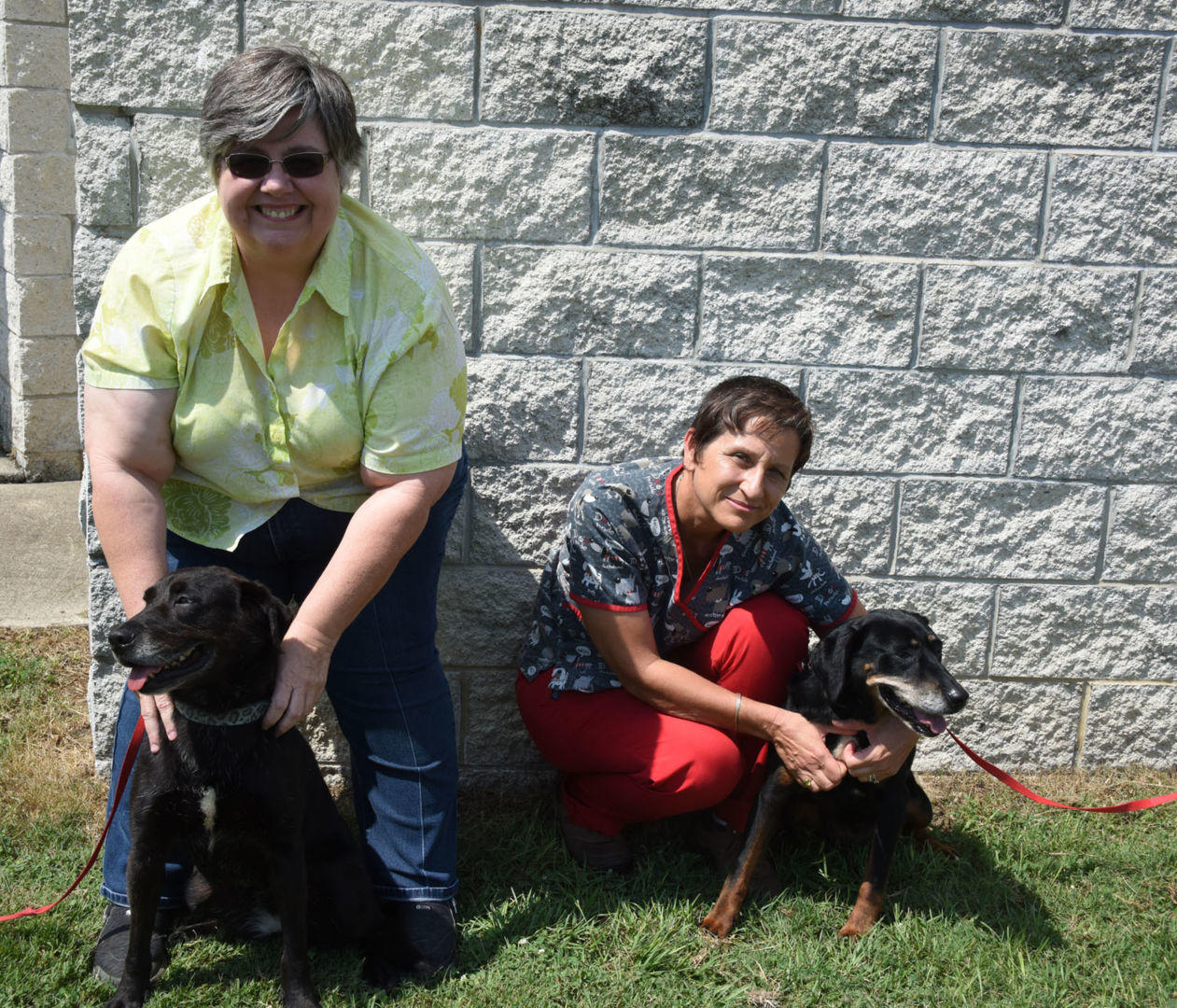 (From left) Dr. Oreta Samples, coordinator of Fort Valley State University’s Master of Public Health program and Ann Gillespie, a FVSU veterinary technician, pose with two dogs from FVSU’s kennel.