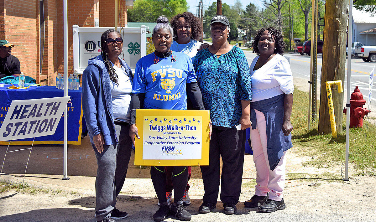 Terralon Chaney (with sign), Fort Valley State University’s Twiggs County Extension agent, poses with participants of the “Twiggs Keep Jammin Walk-A-Thon” in Jeffersonville on April 11.