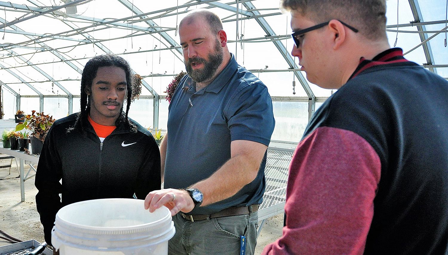 Agricultural education alumni, Jeffrey Wilson, instructs students in the plant science and agricultural mechanics programs at Veterans High School.