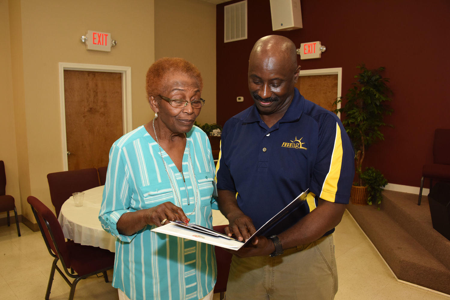 Rosetta May (left) reviews information in a folder she received from Fort Valley State University Laurens County Extension agent Titus Andrews (right) during the Managing Your Land for Profit Workshop in Dublin on May 23.