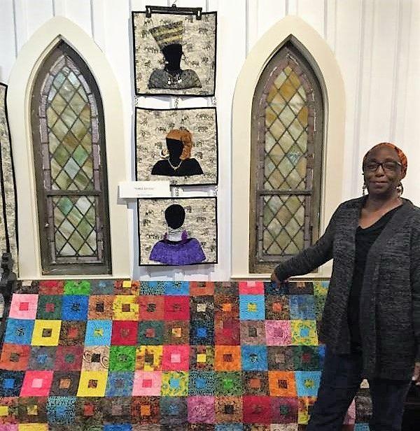 Retired home economics teacher and 1975 Fort Valley State College alumna, Lillie Fowler Singleton of Walterboro, South Carolina poses next to some of the quilts she has crafted.