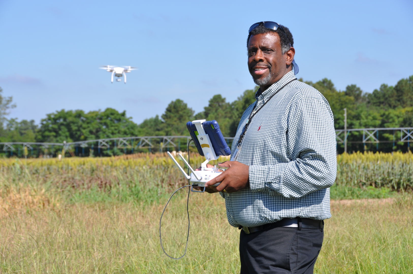 Dr. Archie Williams, head of Fort Valley State University’s Department of Engineering Technology, at the campus research farm using a drone to monitor crop conditions.