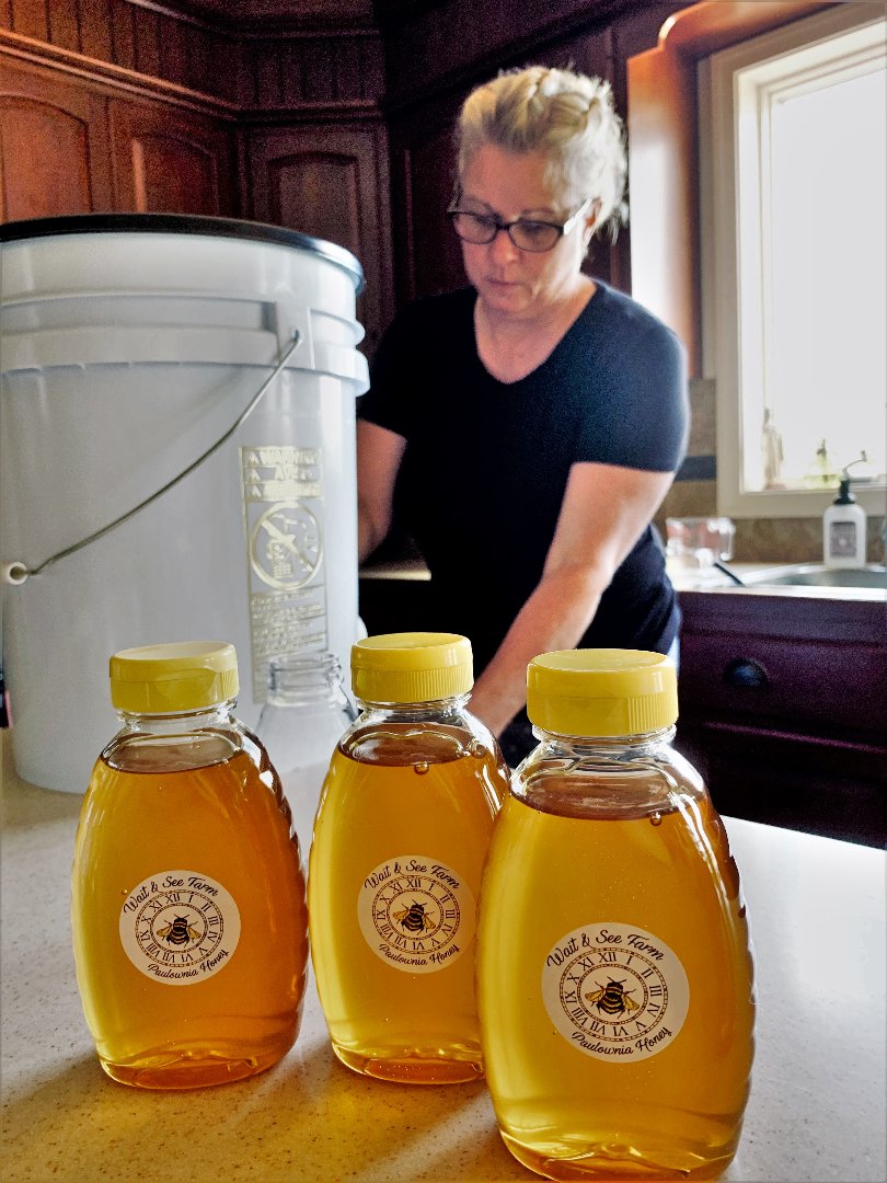 Patricia Doyle of Chester County, Pennsylvania, bottles paulownia honey in her kitchen.