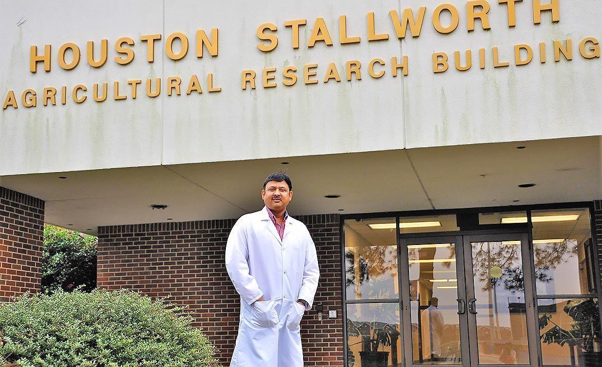 Dr. Hari Singh, Biotechnology Graduate Program Coordinator, standing in front of the Houston Stallworth Agricultural Research Building.