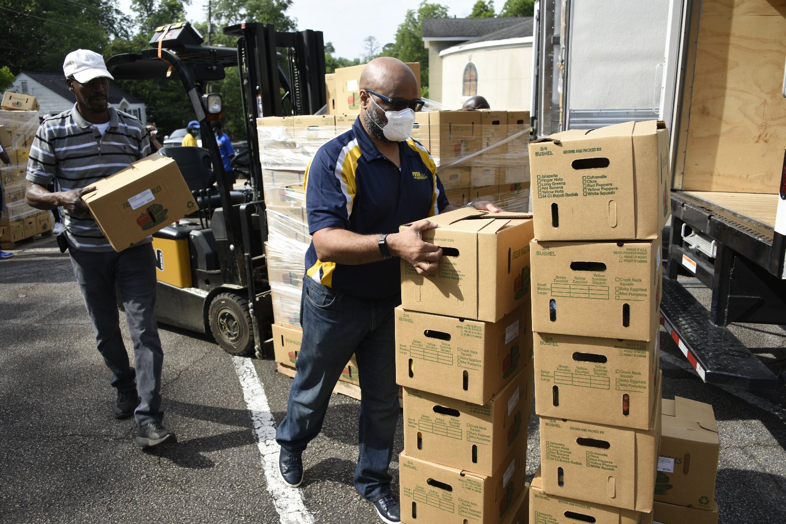 Terrence Wolfork, assistant administrator for communications, conferencing and technology, distributes food from the U.S. Department of Agriculture Farmers to Families Food Box Program in Americus.