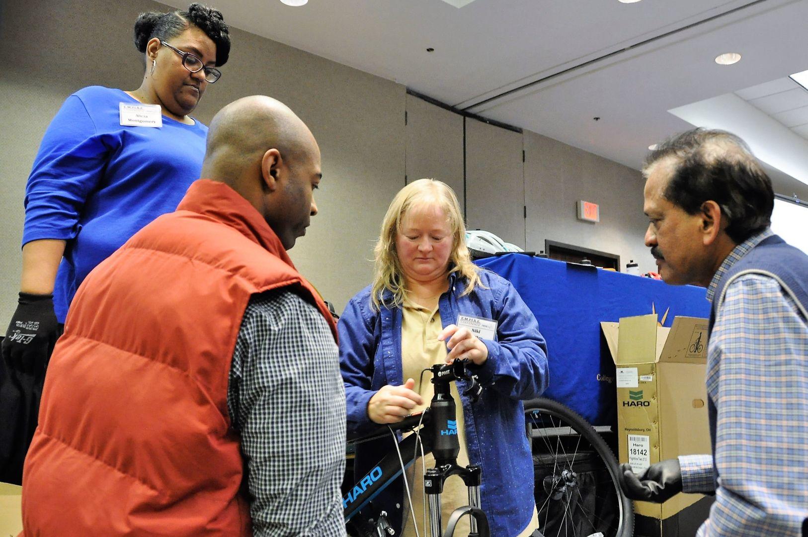 Cooperative Extension and research personnel with Fort Valley State University work as a team to build a bicycle for at-risk youth during the 2017 Empowering and Motivating Personnel in Research and Extension (EMPIRE) Conference.