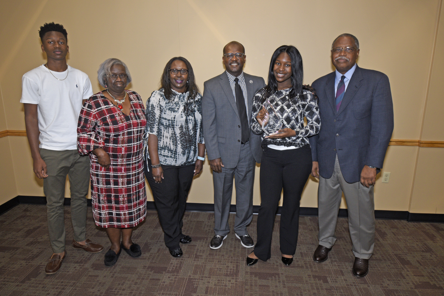 Phillip Petway (fourth from left) and Dr. Mark Latimore Jr. (far right), FVSU Extension administrator, presents Terrica Bond (second from right) and her family with the 4-H Family of the Year Award.