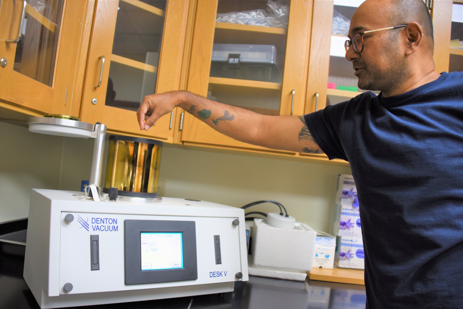 Brajesh Vaidya processes study material using a sputter coater that deposits a thin layer of gold to prevent any damages.