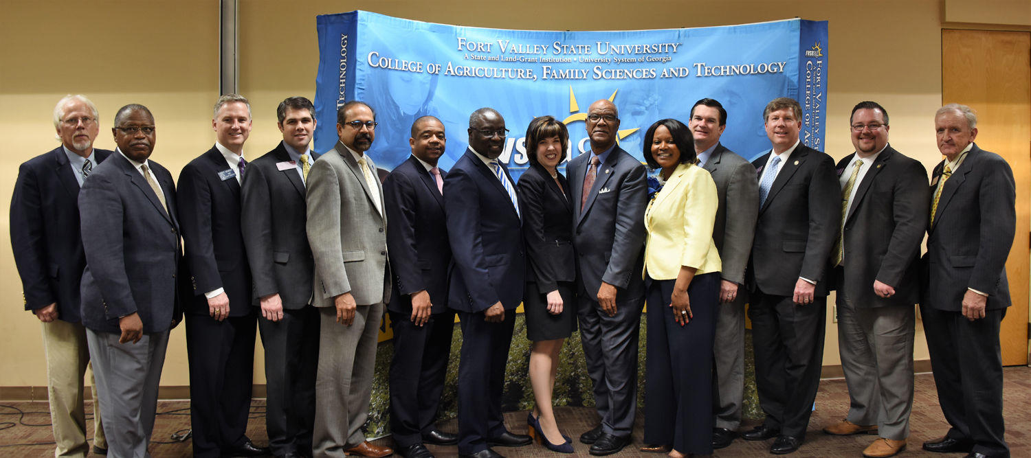 Dr. Paul Jones, president of Fort Valley State University (center); Dr. T. Ramon Stuart, FVSU provost and vice president for academic affairs (left behind Jones); Dr. Govind Kannan, dean of FVSU’s College of Agriculture, Family Sciences and Technology (immediate left behind Stuart) and Dr. Mark Latimore Jr. (second from left), FVSU Extension administrator, pose with Georgia elected officials and other representatives on April 4 in the Pettigrew Center during the 36th annual Ham and Egg Legislative Breakfast.