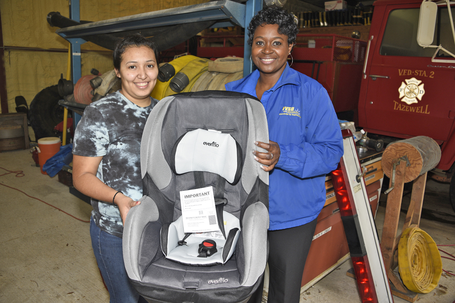 Alejandrina Herrera (left), a native of Buena Vista, holds a brand new car seat she received from Brenda Maddox (right), Fort Valley State University’s Marion County Extension agent, after successfully completing a car seat safety class on Feb. 21.