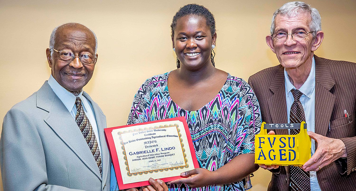 Dr. Ira Hicks (left), a retired Fort Valley State University agricultural education professor, and Dr. Curtis Borne (right), a FVSU agricultural education professor, present sophomore Gabrielle Lindo with the Ira Hicks Outstanding Agricultural Education Major Award and Outstanding Service Award at the 2019 Agri-Demic Forum Awards Banquet.
