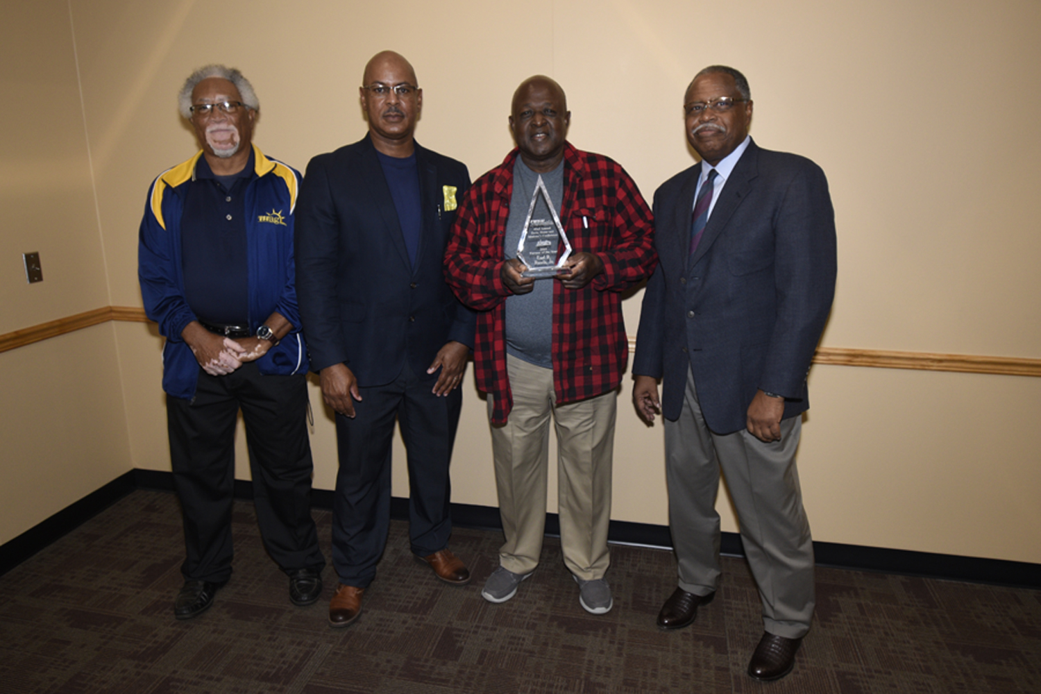 Earl Rawls (holding award) receives the 2019 ANR Farm Family of the Year Award from FVSU Extension personnel (from left) Leon Porter, program assistant for Houston County; Charlie Grace, FVSU Extension agent for Dougherty, Lee and Worthy Counties (far rig
