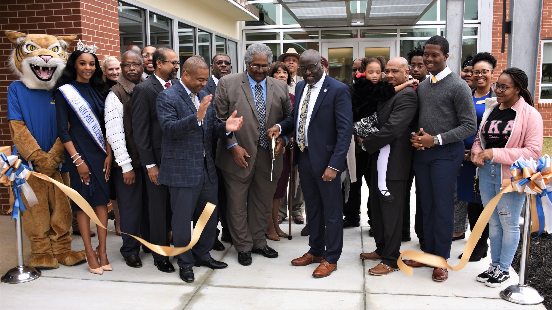 Dr. Paul Jones (center), president of Fort Valley State University, and family members of the late Dr. Cozy L. Ellison participate in a ribbon cutting ceremony for the Cozy Ellison Agricultural Engineering Technology Building. Faculty, staff and students also joined the celebration.