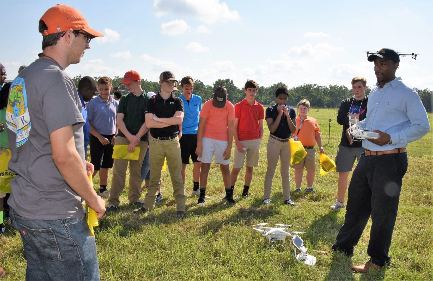 Dr. Cedric Ogden (far right), a Fort Valley State University Extension engineer and assistant professor, demonstrates the use of an unmanned aerial vehicle in research and Extension outreach efforts to Northside High School students and other spectators during Agricultural Field Day on Sept. 14.