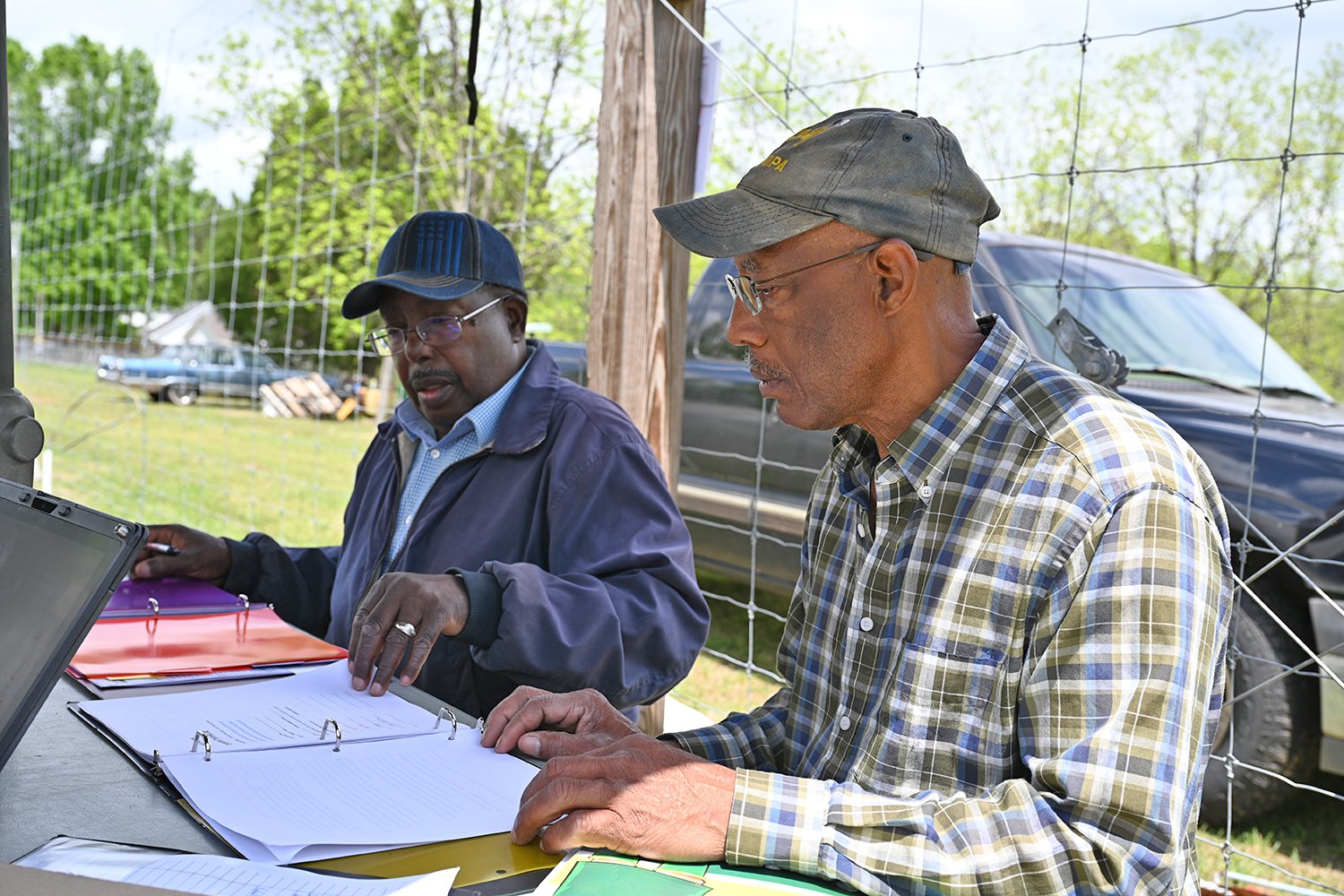 John E. Simmons (left), a Good Agricultural Practices (GAP) consultant, reviews paperwork with Robert Taylor (right),owner of Tilford Farms, during a GAP audit on Taylor’s farm in Houston County, Georgia.