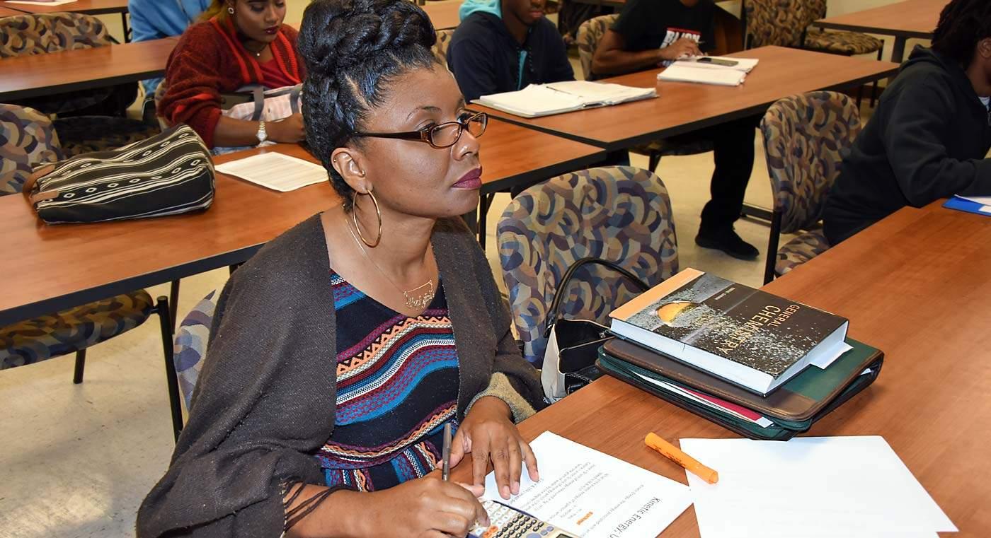Hephzibah Beulah, a non-traditional student at Fort Valley State University, takes notes during chemistry class.
