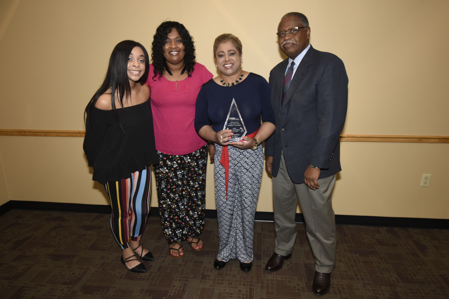 Millicent Price (second from left), FVSU Extension agent for Crawford County and Dr. Mark Latimore Jr. (far right) present Earnestine Jordan (holding trophy) with the 2019 FACS Individual of the Year Award.