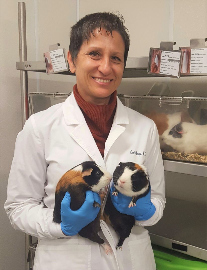 Rose-Ann Gillespie, a Fort Valley State University veterinary technician, embraces two Guinea pigs at the Otis O’Neal Veterinary Science Building.