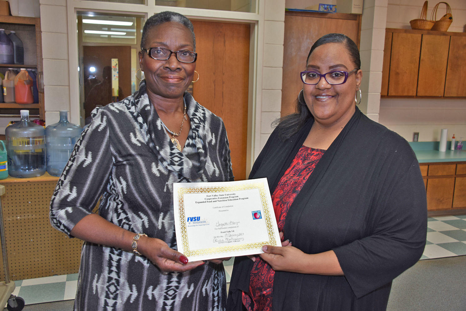 Montezuma native and EFNEP student Gaynette McKenzie (left) and FVSU’s Macon County EFNEP program assistant Alicia Montgomery (right) hold McKenzie’s EFNEP certificate.