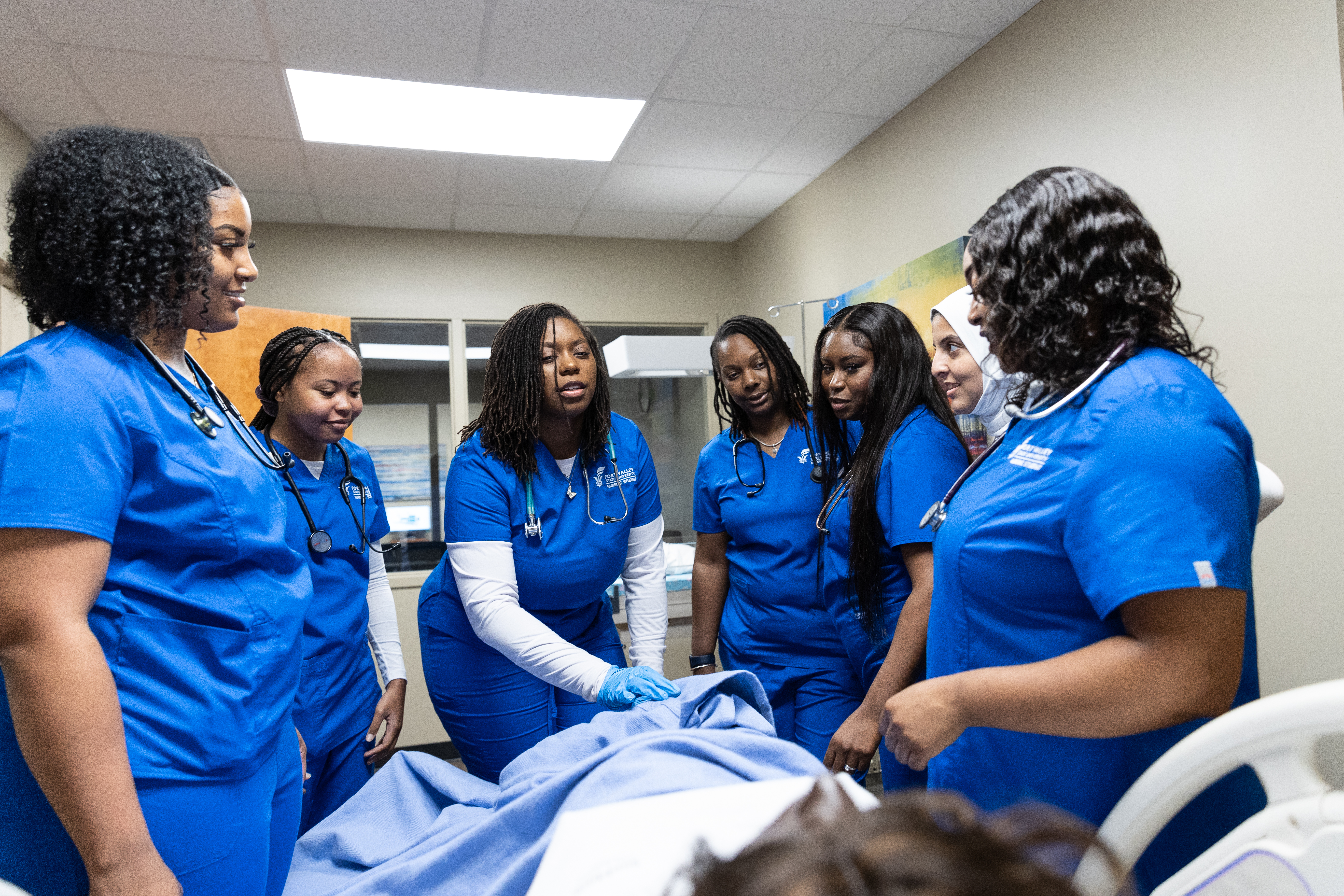 Nurses practicing on dummy