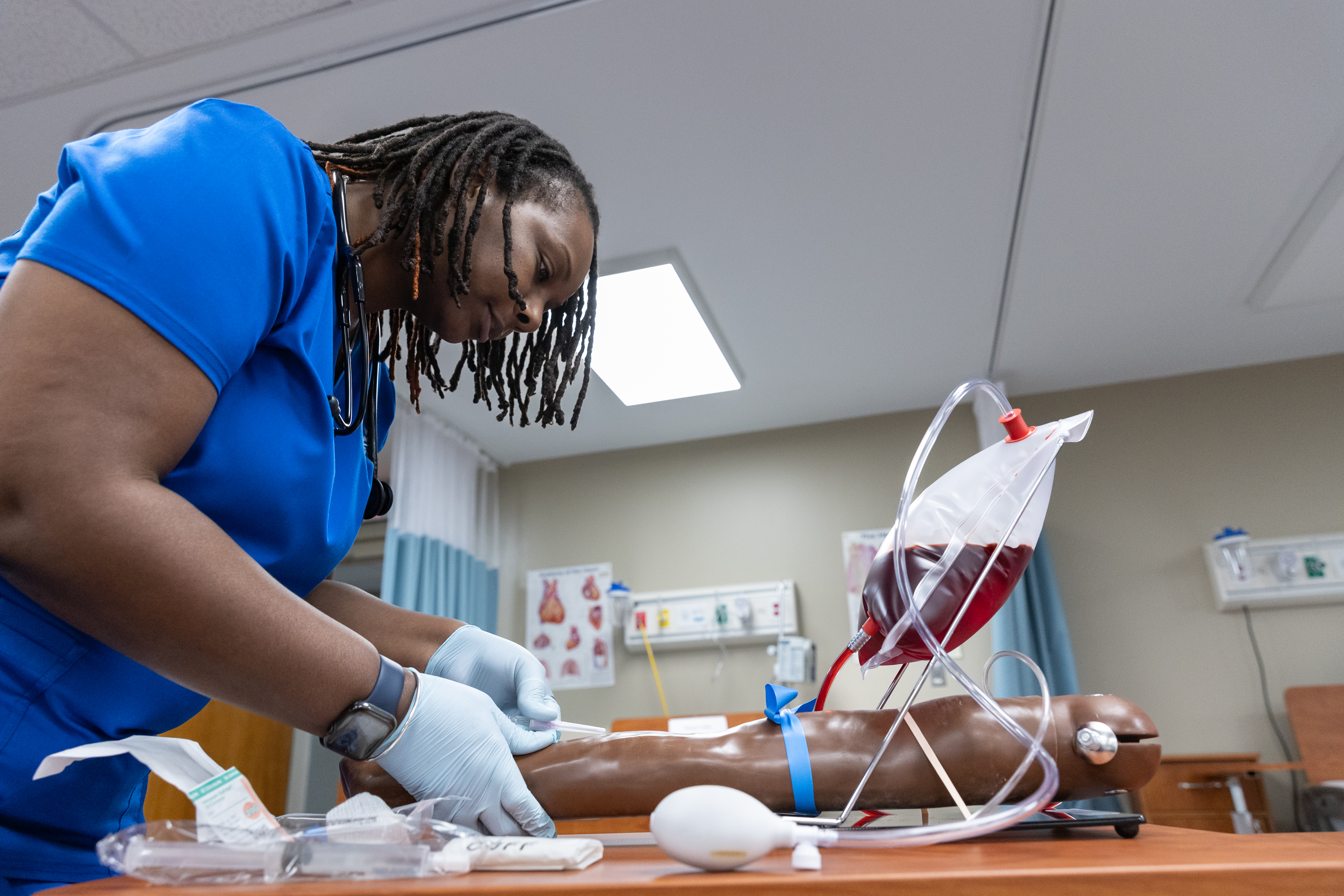 Nursing student demonstrating a blood drawing