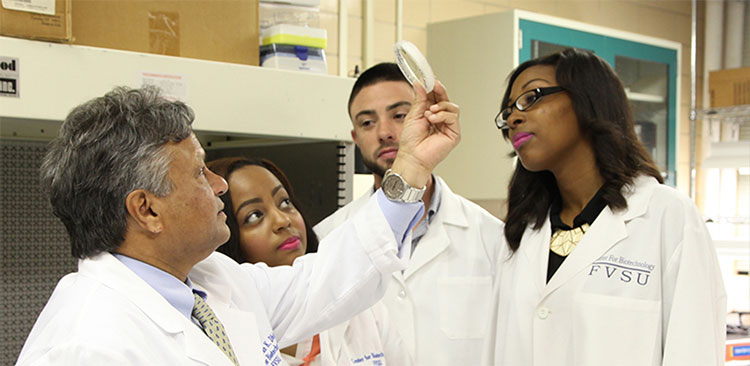 Teacher and students examining item