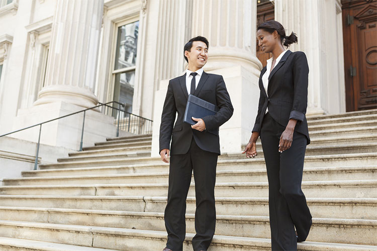 Two people on stairs at courthouse