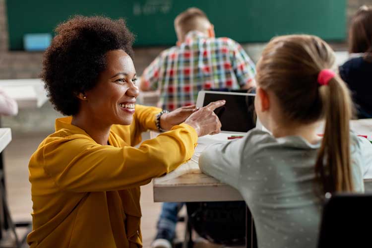 Teacher showing student tablet