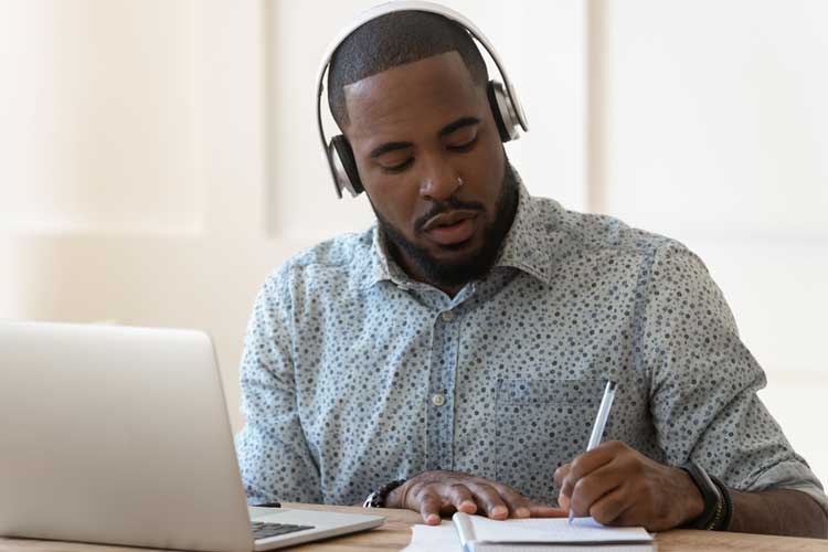 young man with headphones working at computer