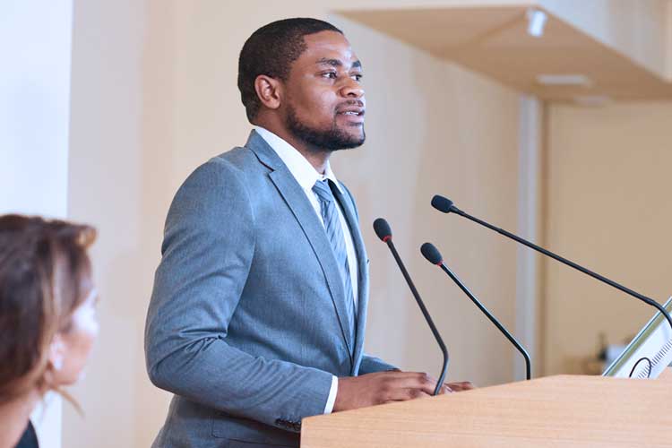 political science student speaking at a podium