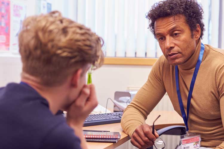 School counselor talking with highschool student