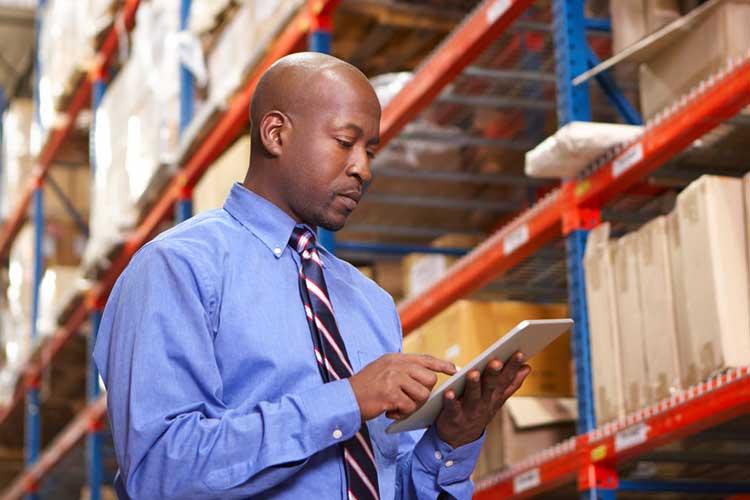 Man inspecting inventory in warehouse