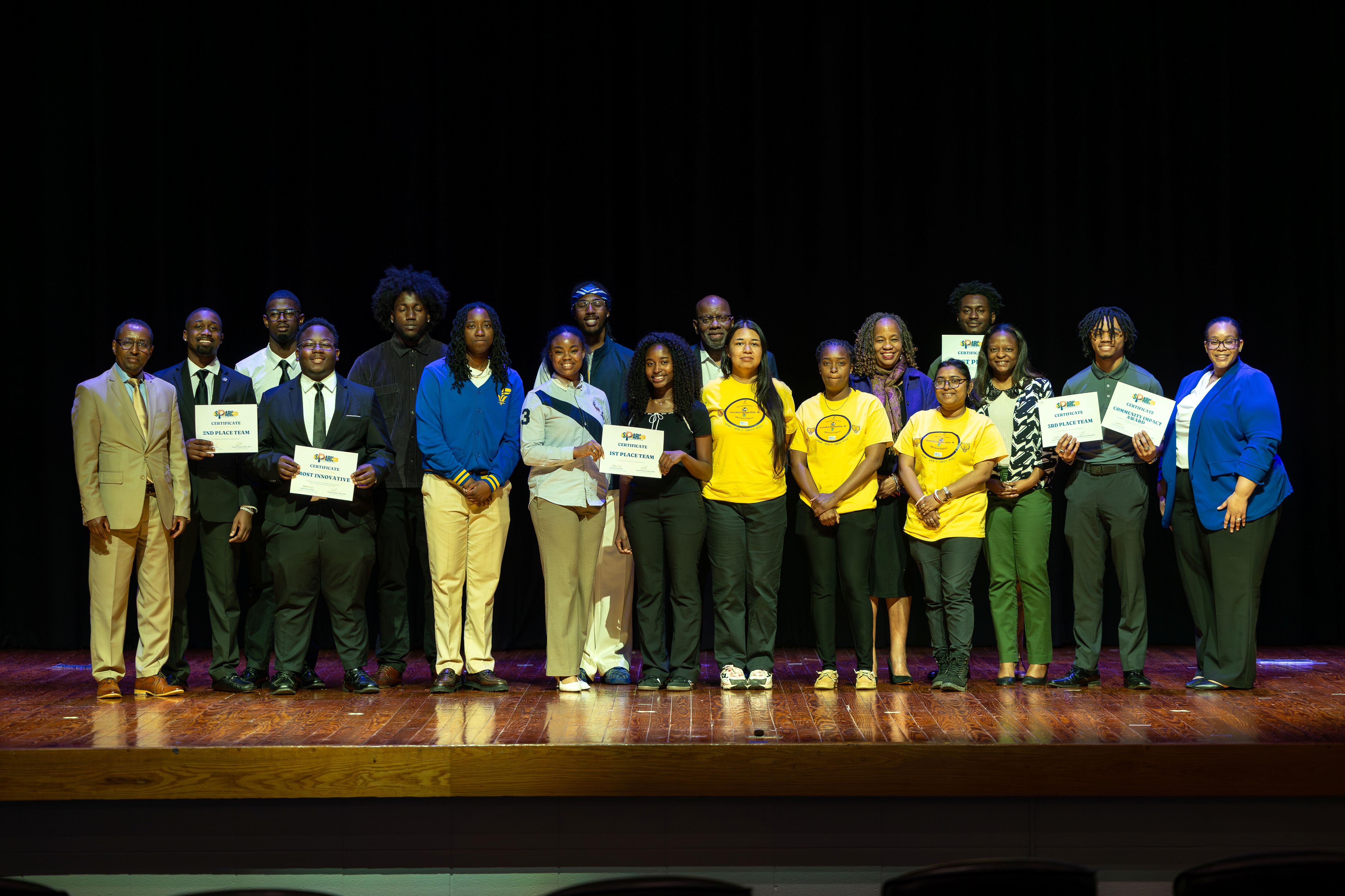 students, faculty and staff standing on stage.